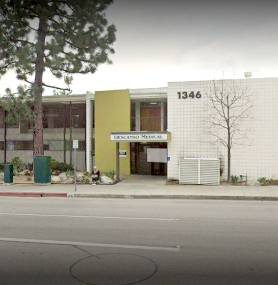 Modern dental office building with yellow and white facade, street address 1346 visible, professional medical facility exterior.